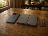 Smartphone, foldable keyboard, and card on a table