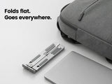 Foldable laptop stand compact design next to backpack showing travel-ready portability